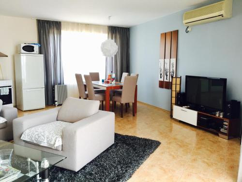 a living room with a white couch and a table at PSB Apartments in Midia Resort Aheloy in Aheloy