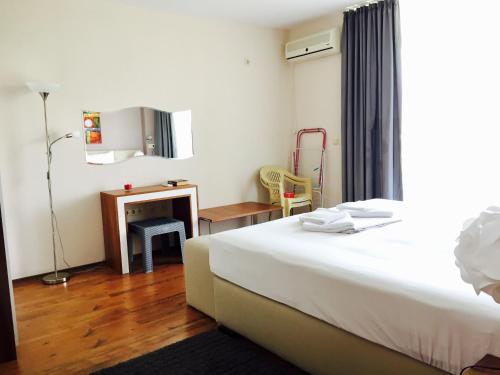 a hotel room with a bed and a table and a desk at PSB Apartments in Midia Resort Aheloy in Aheloy