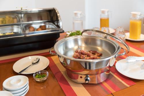 a pot of food sitting on a table at CityHotel Uelzen in Uelzen
