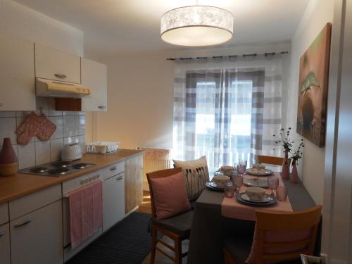 a kitchen with a table and a dining room at WohlFühlPlatz´l in Stegersbach
