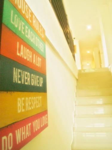 a stairwell with a sign on a wall with stairs at LEOS Hotel in Tomohon