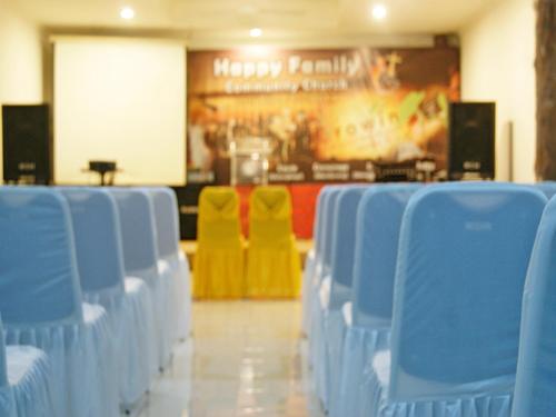 a row of blue chairs in a room at LEOS Hotel in Tomohon