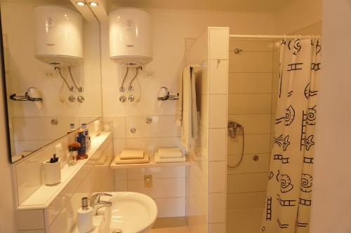 a bathroom with a sink and a shower at Stella Mare Apartments in Podstrana