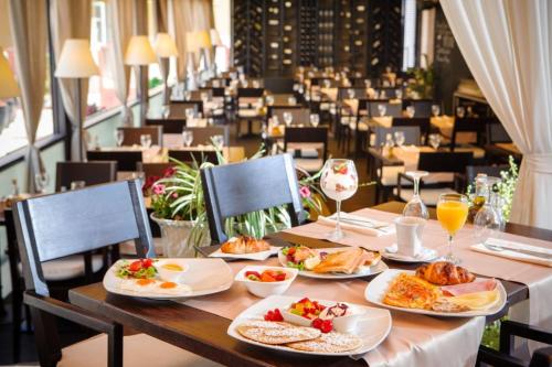 a table with plates of food on top of it at Prima Luxury Rooms in Split