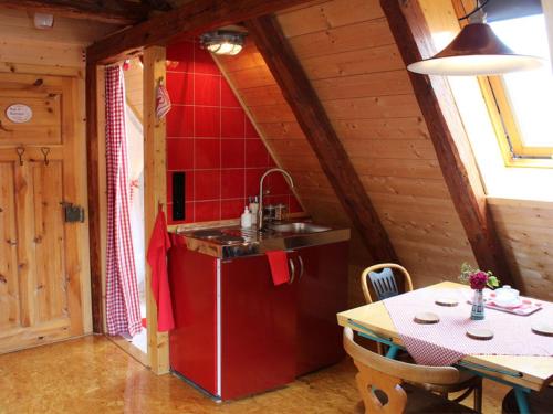 a kitchen with a sink and a table in a room at Ferienwohnungen Taubenschlag in Creglingen