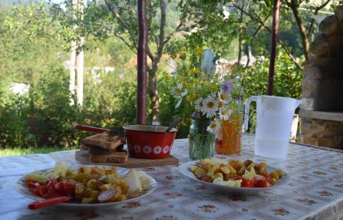 a table with two plates of fruit on it at Casa Petri Rosia Montana in Roşia Montană
