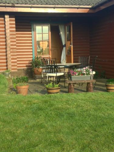 a patio with a table and chairs on a house at Balnabrechan Lodge in Arbroath