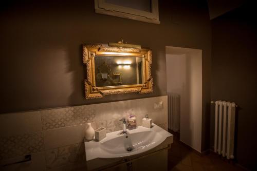a bathroom with a sink and a mirror on the wall at Giardini 82 B&B in Gravina in Puglia