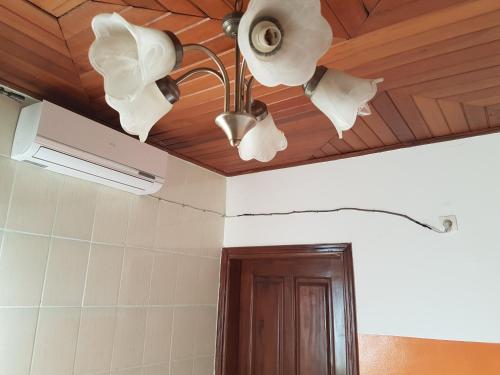 a room with a ceiling with a light and a door at Maison Rose in Douala