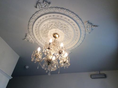 a chandelier hanging from a ceiling in a room at Alma Lodge Guest House in Plymouth