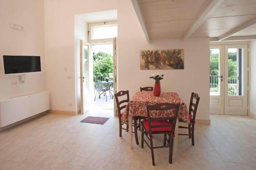 a dining room with a table and chairs at Villa Rosato in Selva di Fasano