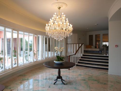 a large room with a chandelier and a table at Luna Hotel Turismo in Abrantes