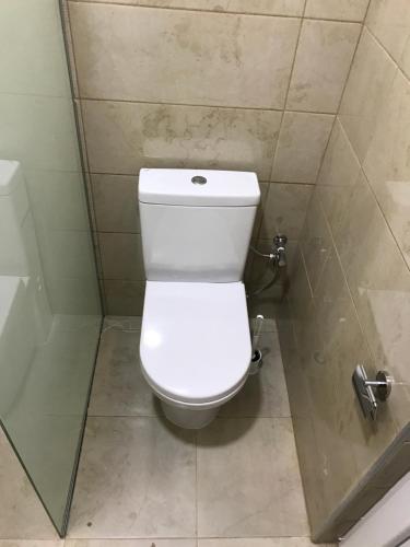 a bathroom with a white toilet in a shower at Villa Nina Hotel & Lounge bar in Skopje