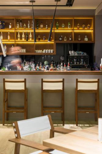a restaurant with two chairs and a counter with items at Angelica Hotel in Limenas