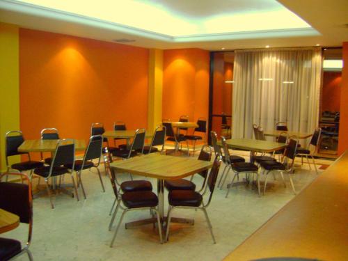 a restaurant with wooden tables and chairs in a room at Hotel Le-Gar in Monterrey