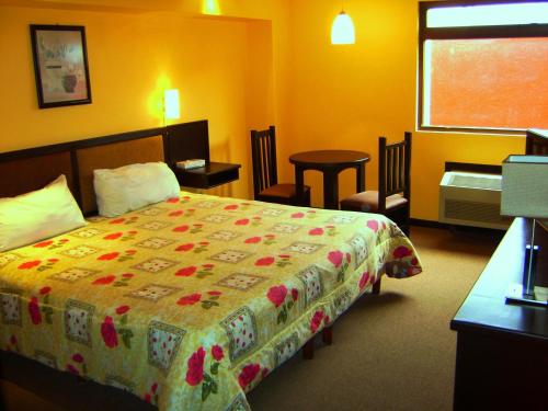 Ένα ή περισσότερα κρεβάτια σε δωμάτιο στο Hotel Le-Gar