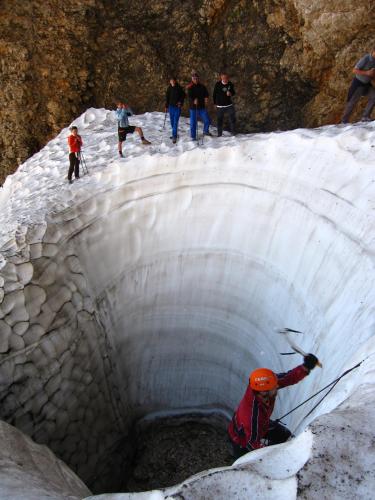 a group of people walking through a snow tunnel at Boutique rooms Pri Rogovilcu in Solčava