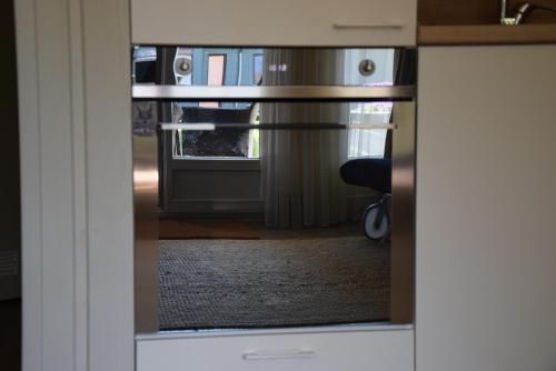 a view through a glass door into a room at Marių pelėdos in Preila