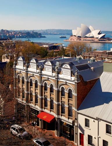 an aerial view of a building with the opera house at Harbour Rocks by Ode Hotels in Sydney