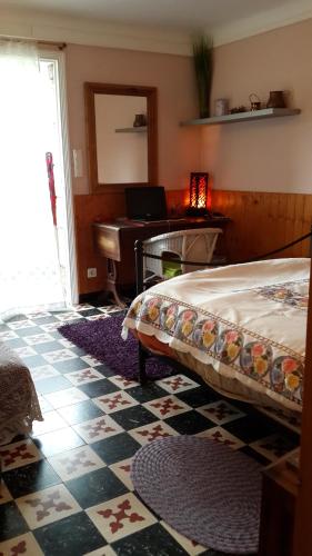 a bedroom with a bed and a desk and a piano at Lovely house in Cagnes-sur-Mer