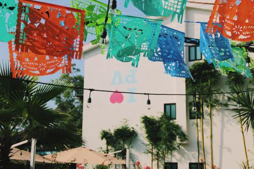 a building with colorful flags hanging in front of it at San Trópico Boutique Hotel & Peaceful Escape in Puerto Vallarta
