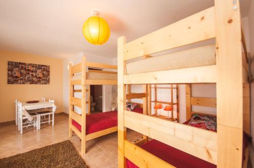 a room with two bunk beds and a table at Rivers Nation Surf Camp in Atouguia da Baleia