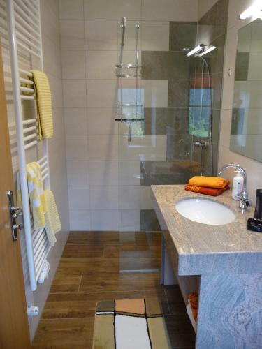 a bathroom with a sink and a shower at Ferienhaus Enzi in Weissbriach