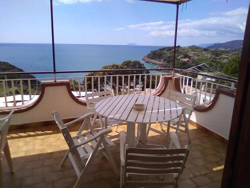 a table and chairs on a balcony with a view of the ocean at La Terrazza Sul Mare in Gaeta