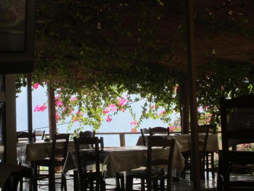 a table with chairs and a view of the water at Sfinias Apartments in Kali Limenes