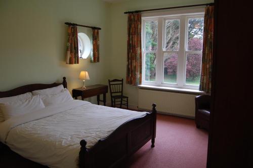 a bedroom with a bed and a window at Ardtarmon House in Sligo