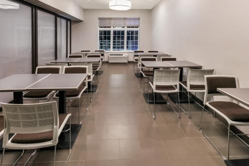 an empty cafeteria with tables and chairs at Permian Studio Apartments in Monahans