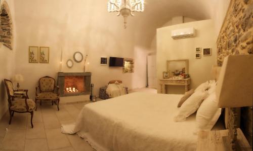 a bedroom with a large bed and a fireplace at Mesta Mastic in Mestá