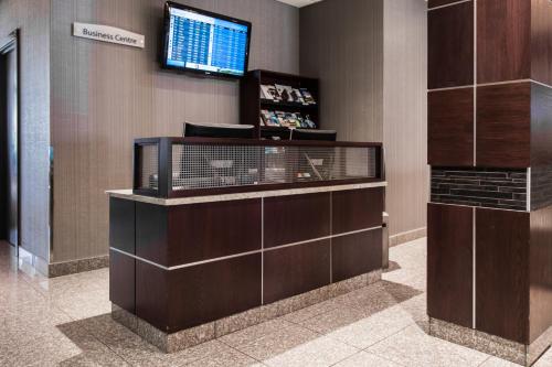 a lobby with a television on a wall at Park Town Hotel in Saskatoon