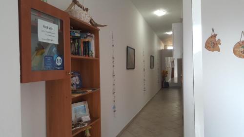 a hallway with bookshelves and a hallway with a hallway at Sofia Studios & Apartments in Georgioupolis