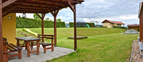 a patio with a table and chairs and a playground at Apartmány Vojta in Telč