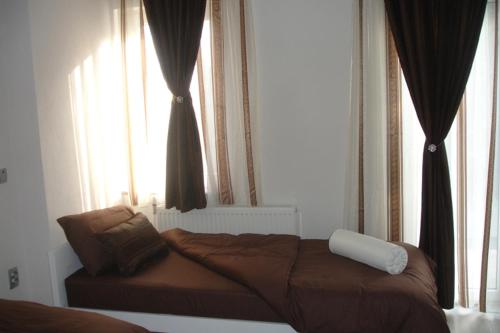 a bed sitting in a room with a window at Hotel Scorpion in Kruševo