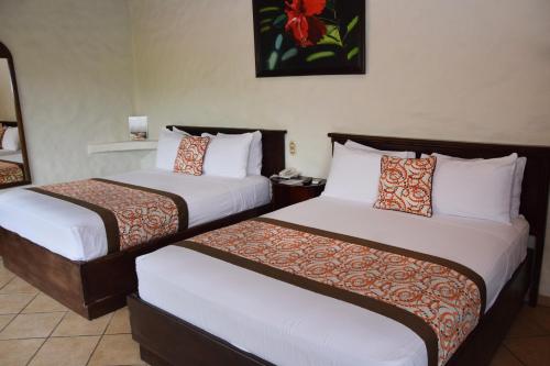 Кровать или кровати в номере Arenal Volcano Inn