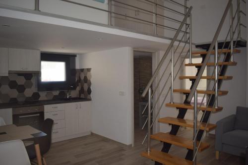 a living room with a spiral staircase in a loft at Selena Villa in Kamari