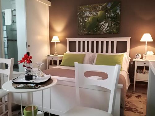 a bedroom with a bed and a table and chairs at Casa del Corso in Taviano
