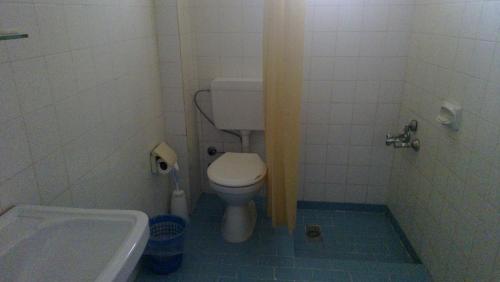 a small bathroom with a toilet and a tub at Mer in Fethiye