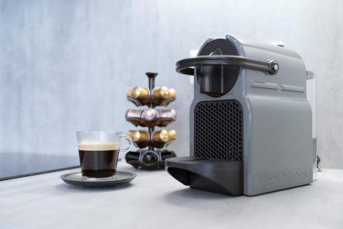 a coffee maker and a cup of coffee on a table at MyApartment in the city center in České Budějovice