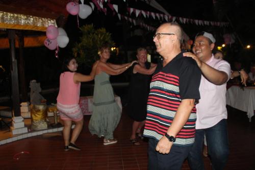a group of people dancing at a party at Sarinande Hotel in Seminyak