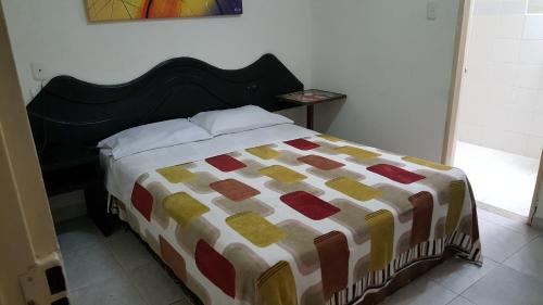 a bed with a colorful comforter in a bedroom at Hotel Vermon Armenia in Armenia