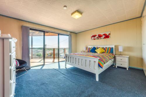 a bedroom with a bed and a sliding glass door at Bayviews in Portarlington