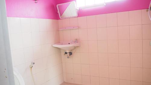a bathroom with a sink and a mirror at Charinsup Hotel in Ban Khlong Thai Muang