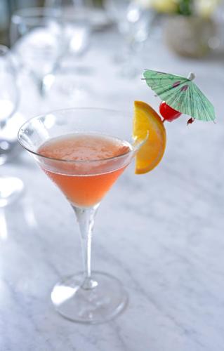 a drink in a martini glass with an orange slice at Rumah Luwih Bali in Keramas