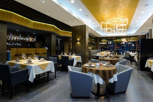 Hotel Senator في كاراغاندي: مطعم بطاولات وكراسي وثريا