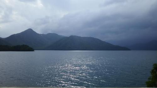 a large body of water with mountains in the background at Guest House Koundo in Nikko