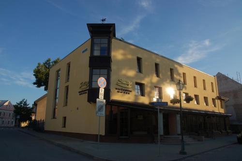 a building on the corner of a street at Hotel-Restaurant Smilga in Kėdainiai