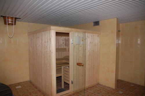 a room with a closet with wooden walls and a ceiling at Hotel-Restaurant Smilga in Kėdainiai